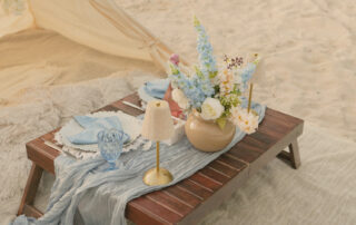 Elegant picnic table setting with fresh flowers and candlelight