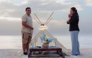 Boho teepee proposal setup on the beach at sunset